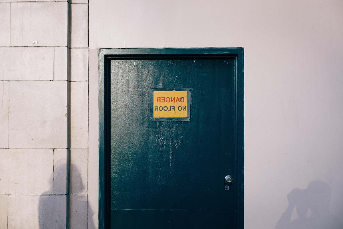 united states blue wooden door with gold and black signage door